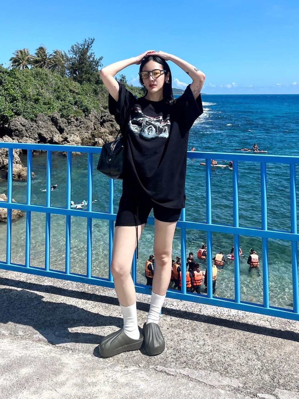 ブラック系のカーゴパンツを着用したレディースの夏コーディネートの2枚目の写真