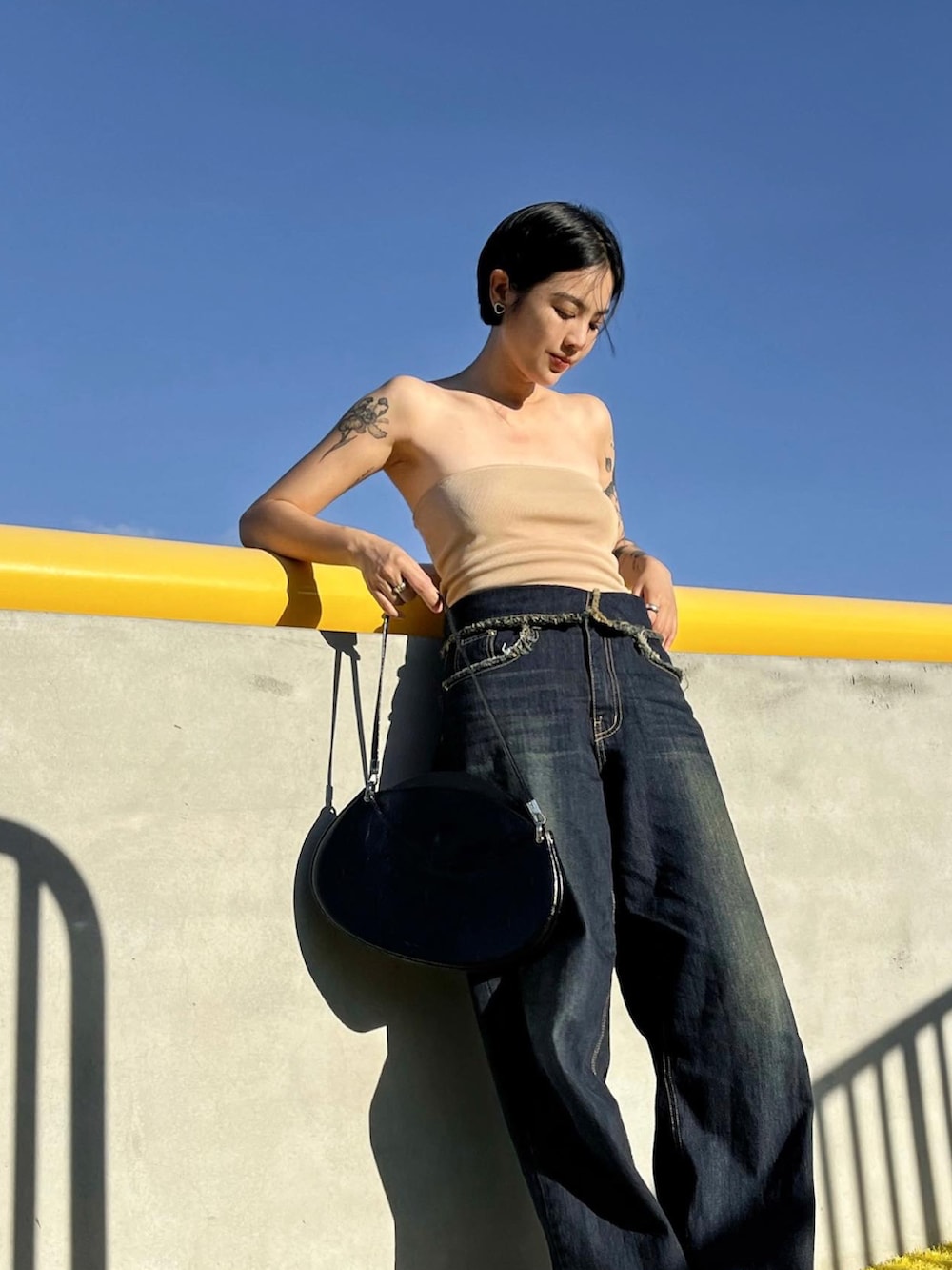 ブラック系のデニムパンツを着用したレディースの夏コーディネートの3枚目の写真