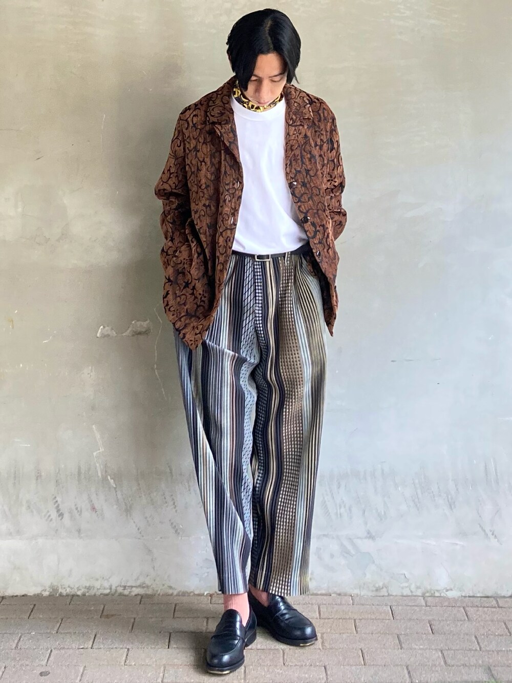 ブラウン系のテーラードジャケット、ホワイト系のTシャツ/カットソー、ベージュ系のパンツを着用したメンズの春コーディネートの3枚目の写真