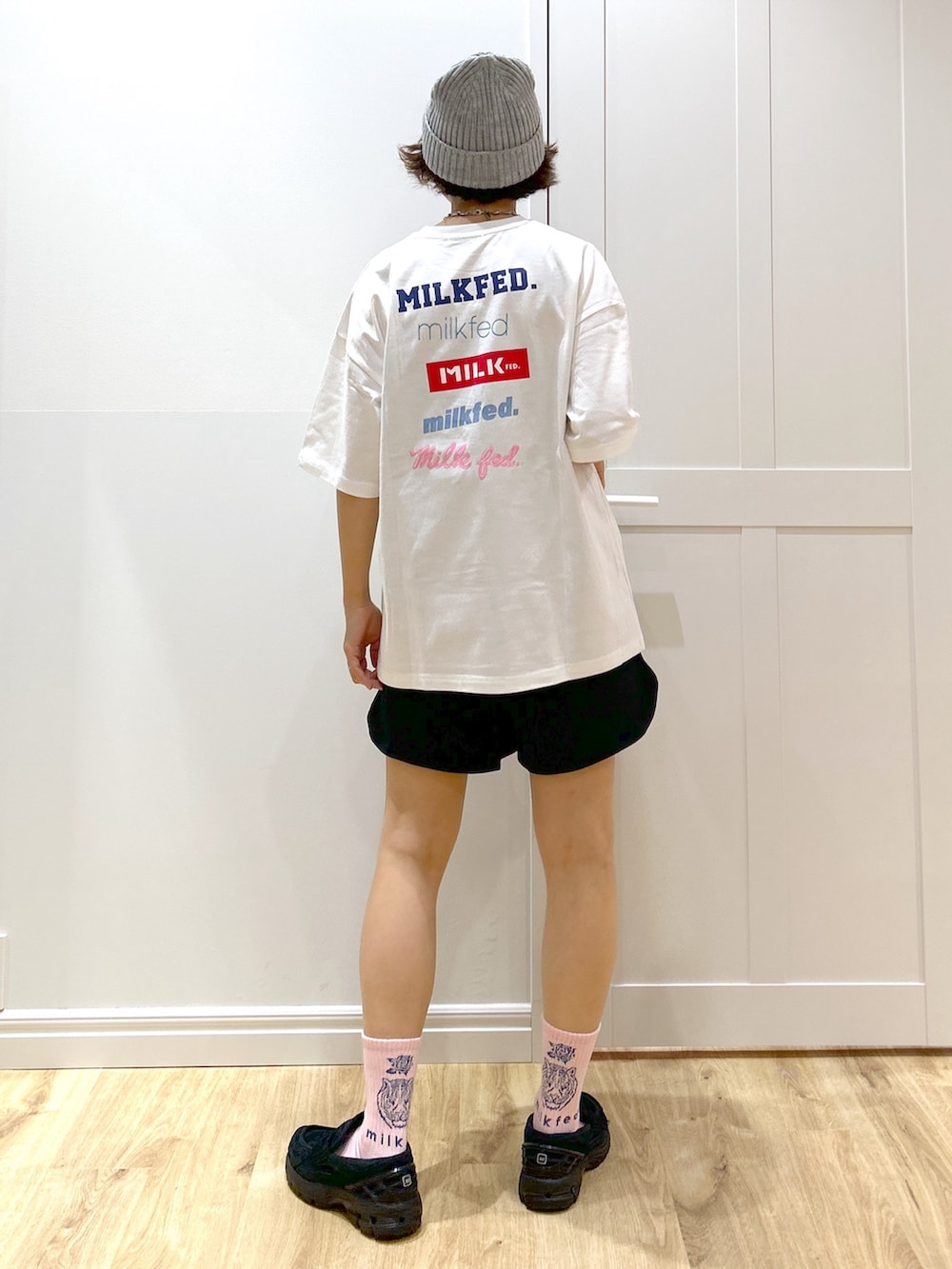 ブラック系のスウェットパンツ、ホワイト系のTシャツ/カットソー、パープル系のトートバッグを着用したレディースの夏コーディネートの4枚目の写真