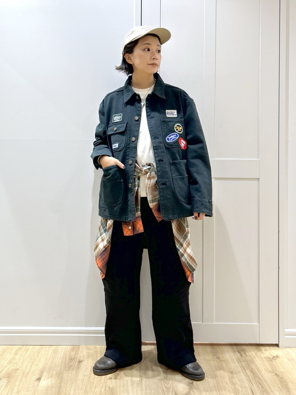 オレンジ系のシャツ/ブラウス、ブラック系のブルゾン、ホワイト系のTシャツ/カットソーを着用したレディースの秋コーディネートの4枚目の写真