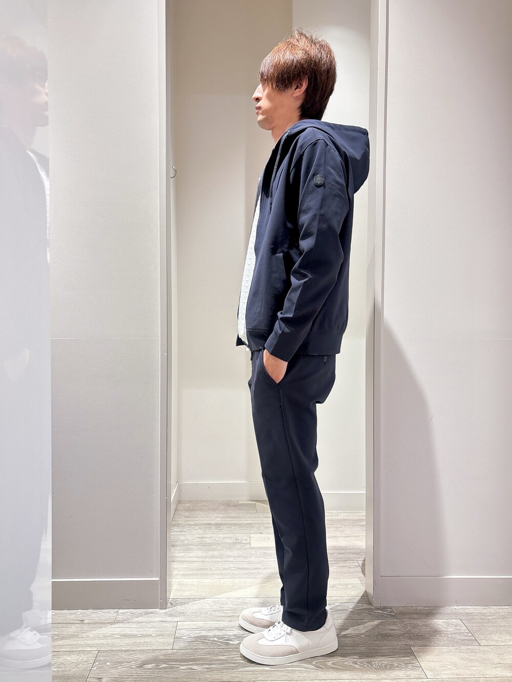 ブルー系のパーカー、ホワイト系のTシャツ/カットソー、ブルー系のスラックスを着用したメンズの秋コーディネートの2枚目の写真