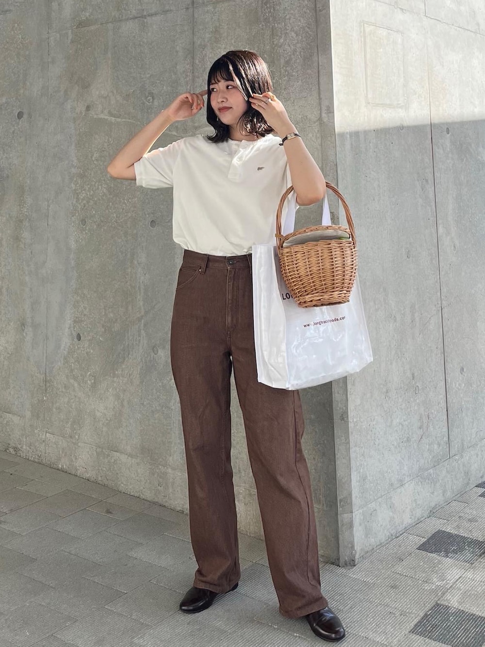 ブラウン系のデニムパンツ、ホワイト系のTシャツ/カットソー、ブラウン系のドレスシューズを着用したレディースの夏コーディネートの2枚目の写真