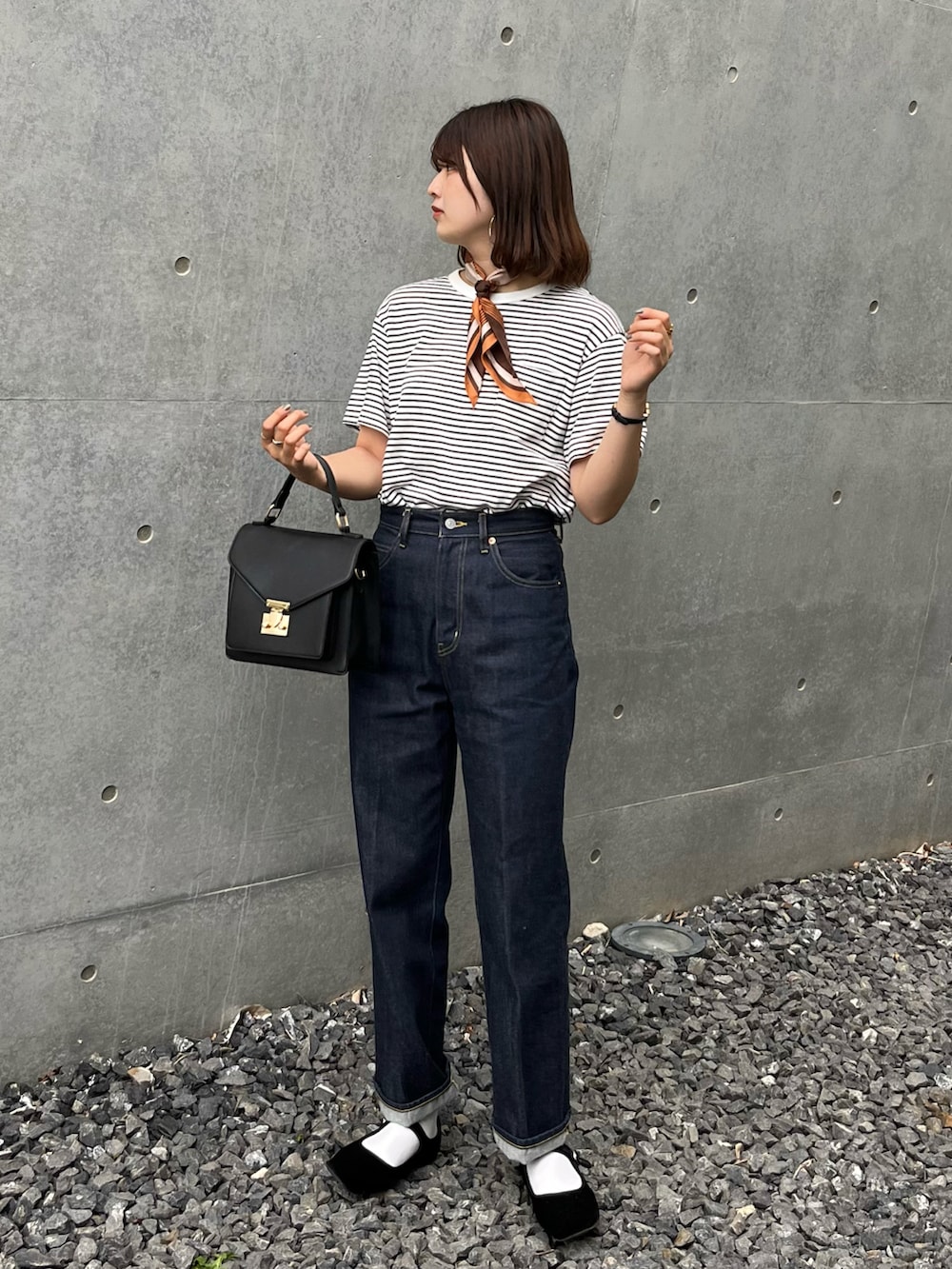 ブラック系のバレエシューズ、ブルー系のデニムパンツ、ブラック系のTシャツ/カットソーを着用したレディースの夏コーディネートの3枚目の写真