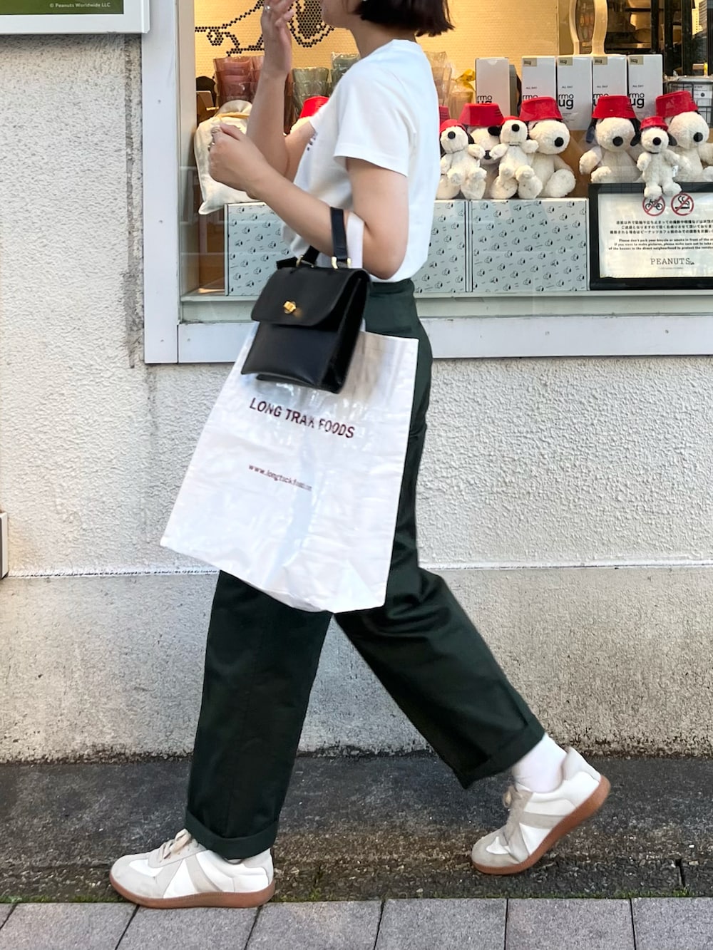 ブラック系のショルダーバッグ、グリーン系のその他パンツ、ホワイト系のシューズを着用したレディースの夏コーディネートの2枚目の写真
