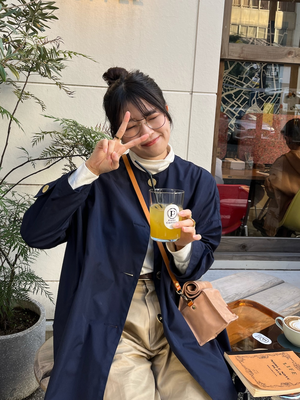 ベージュ系のチノパンツ、ブラウン系のドレスシューズ、ブルー系のその他アウターを着用したレディースの秋コーディネートの3枚目の写真