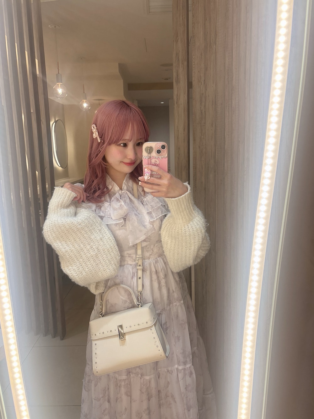 ピンク系のワンピース/ドレス、ピンク系のパンプス、ホワイト系のショルダーバッグを着用したレディースの春コーディネートの2枚目の写真