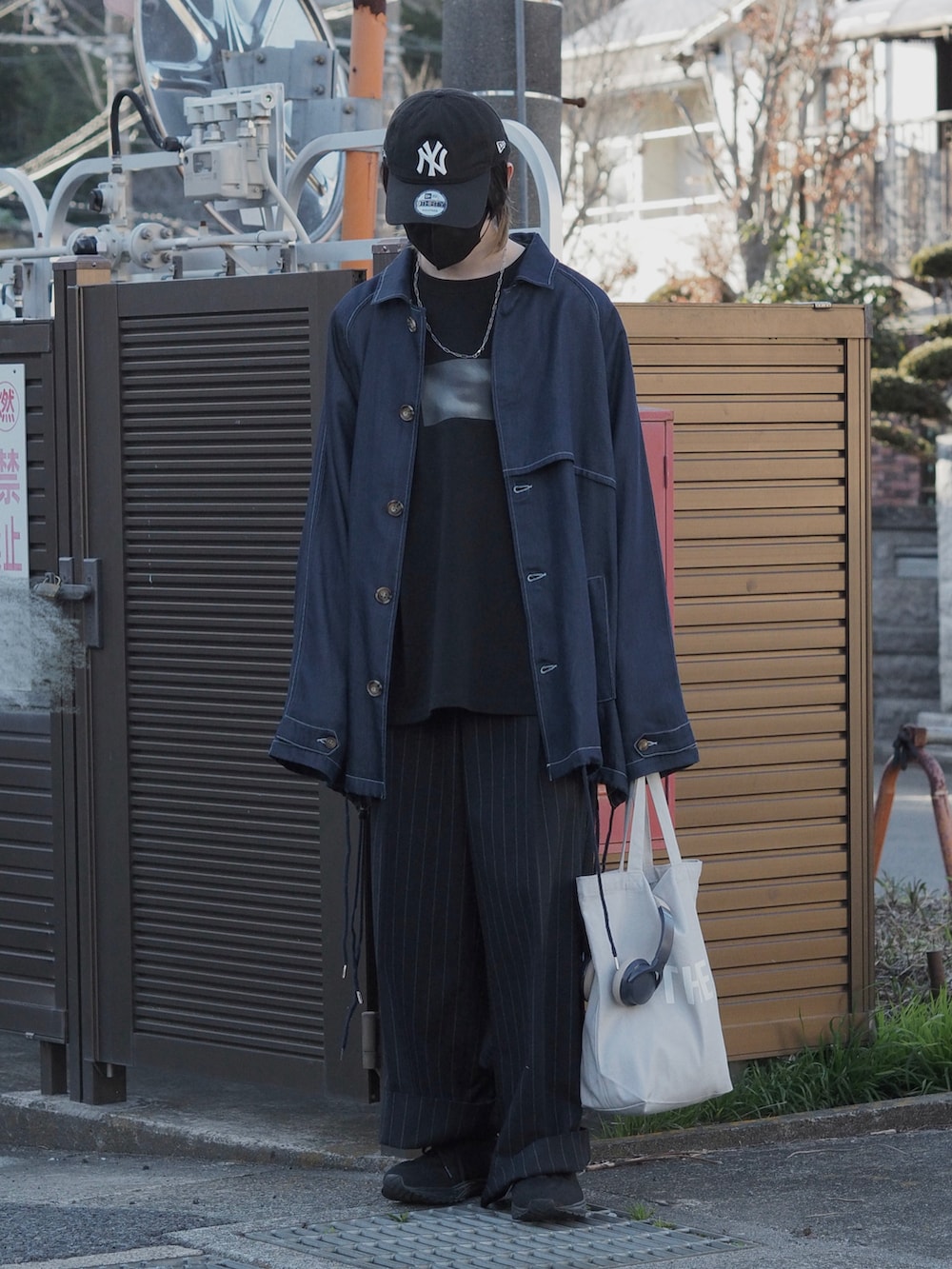 ブルー系のデニムジャケット、グレー系のスラックス、ブラック系のTシャツ/カットソーを着用したメンズの春コーディネートの2枚目の写真