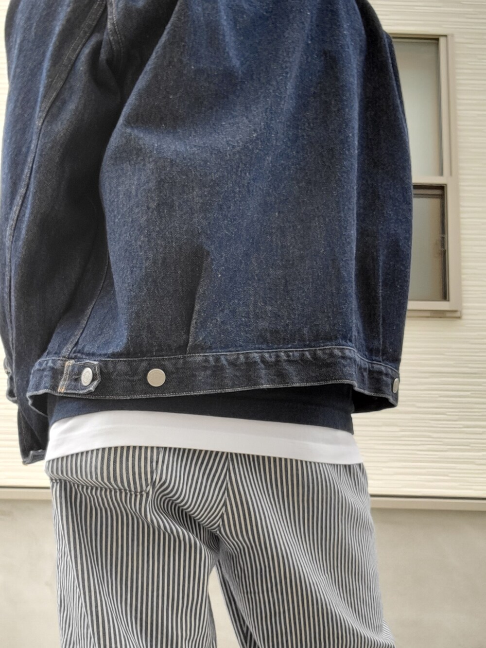 ブルー系のスニーカー、ブルー系のパンツ、ホワイト系のタンクトップを着用したメンズの秋コーディネートの2枚目の写真