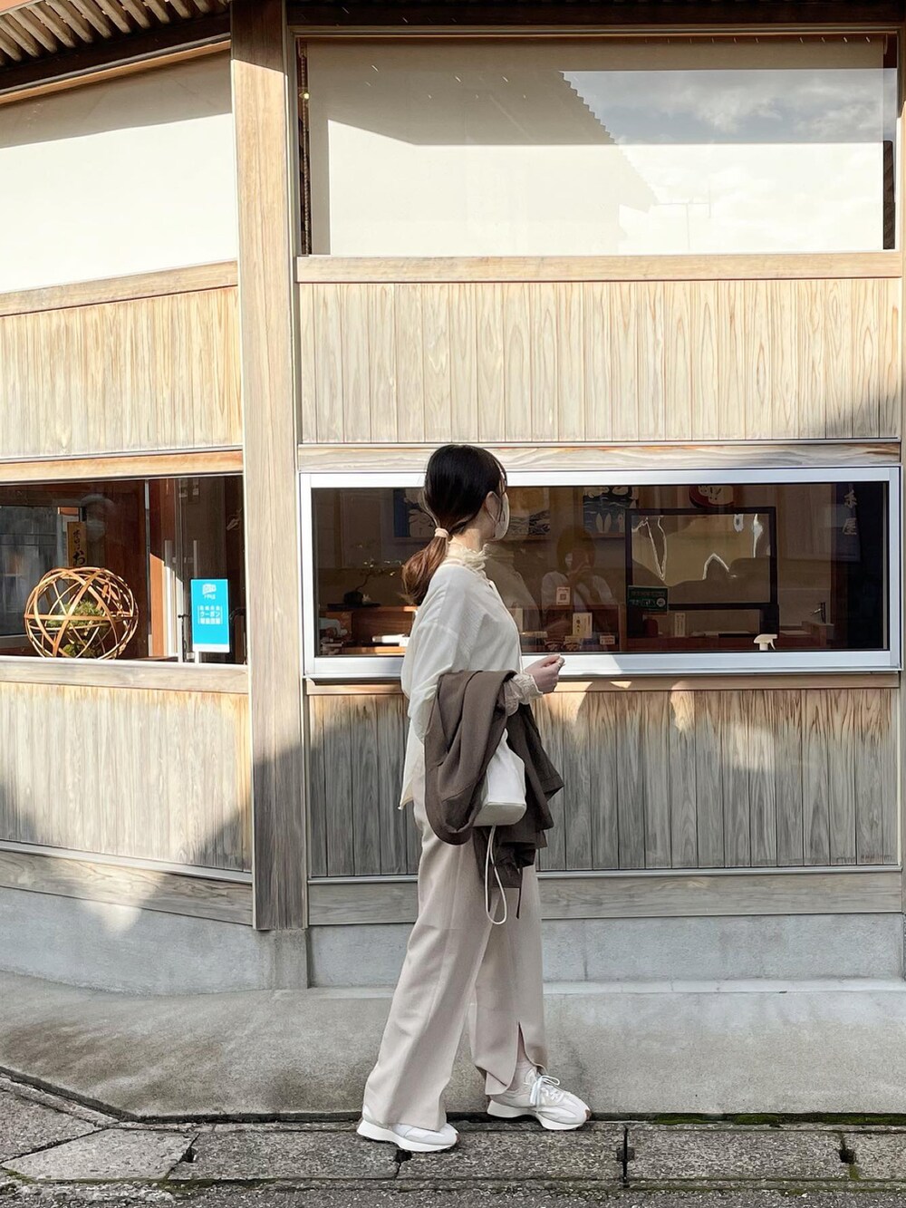 ベージュ系のパンツを着用したレディースの秋コーディネートの2枚目の写真