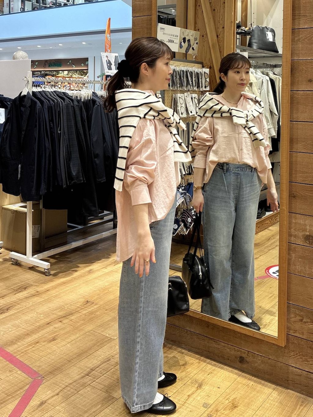 ブラック系のバレエシューズ、ブルー系のデニムパンツ、ピンク系のシャツ/ブラウスを着用したレディースの春コーディネートの2枚目の写真