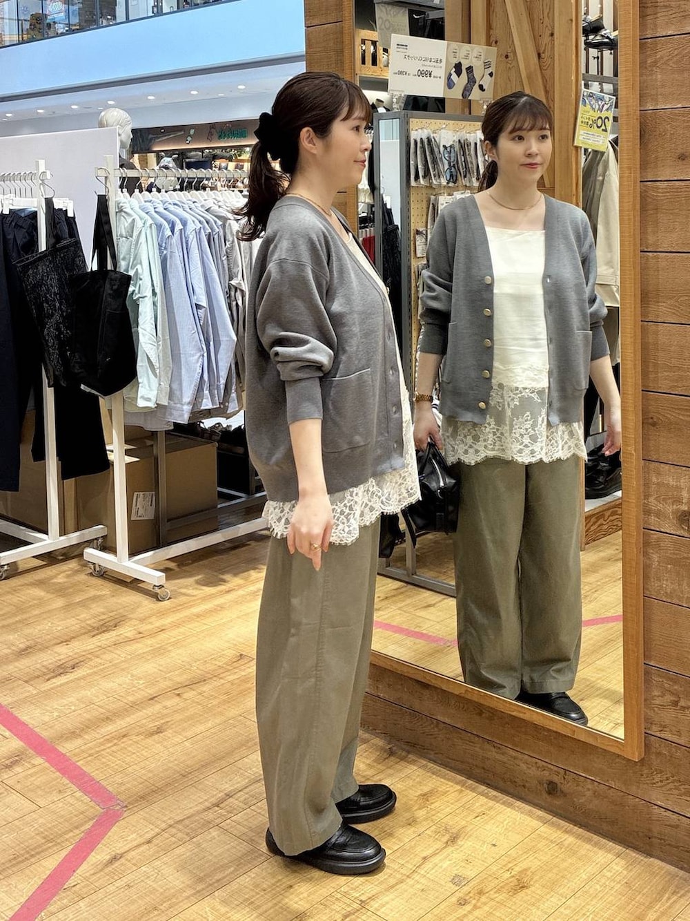 グレー系のカーディガン/ボレロ、グリーン系のその他パンツ、ホワイト系のキャミソールを着用したレディースの春コーディネートの2枚目の写真