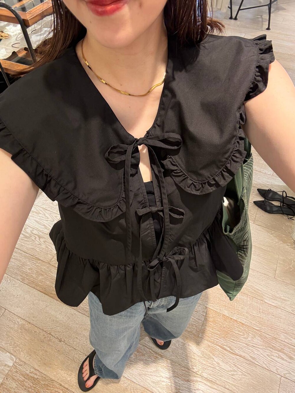 ブルー系のデニムパンツ、ブラック系のシャツ/ブラウスを着用したレディースの夏コーディネートの3枚目の写真