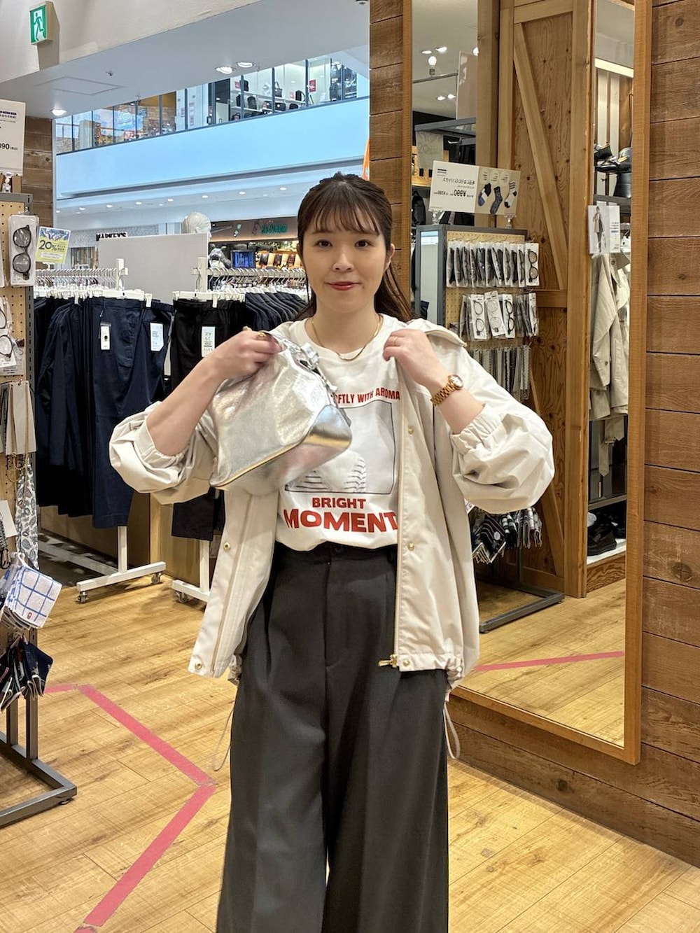 シルバー系のショルダーバッグ、ベージュ系のマウンテンパーカー、グレー系のその他パンツを着用したレディースの春コーディネートの4枚目の写真