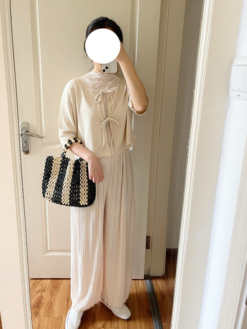 ブラック系のトートバッグ、ホワイト系のその他パンツ、ホワイト系のカーディガン/ボレロを着用したレディースの夏コーディネートの2枚目の写真