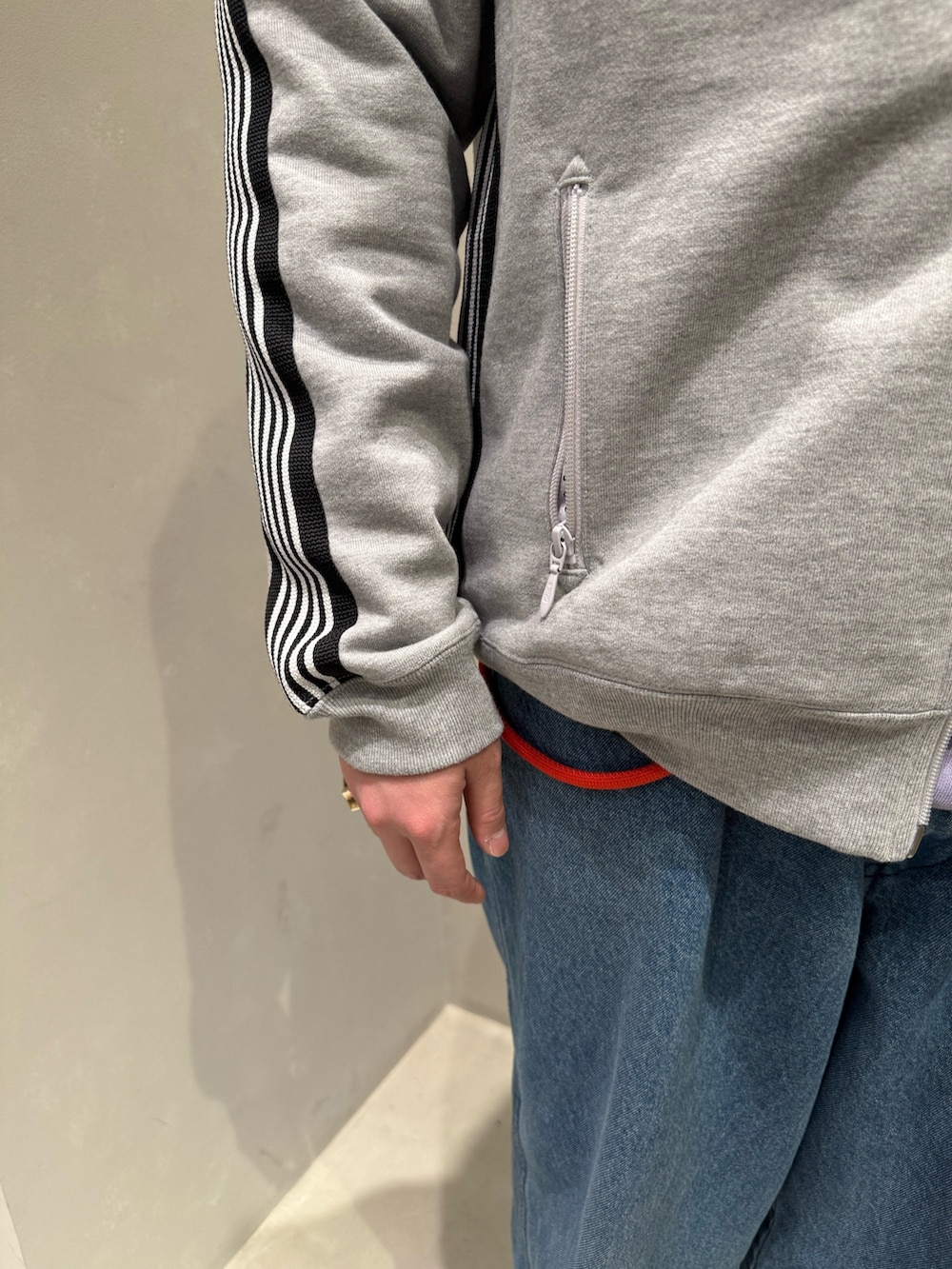 ブラック系のスニーカー、ブルー系のデニムパンツを着用したメンズの冬コーディネートの5枚目の写真