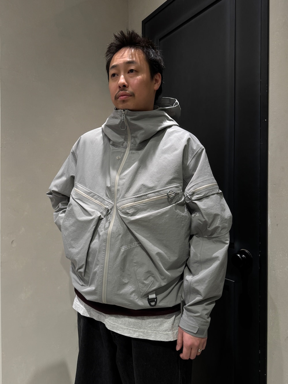 グレー系のマウンテンパーカーを着用したメンズの冬コーディネートの2枚目の写真