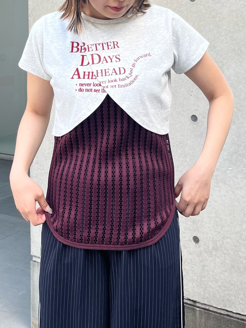 グレー系のTシャツ/カットソー、レッド系のタンクトップ、レッド系のサンダルを着用したレディースの夏コーディネートの3枚目の写真