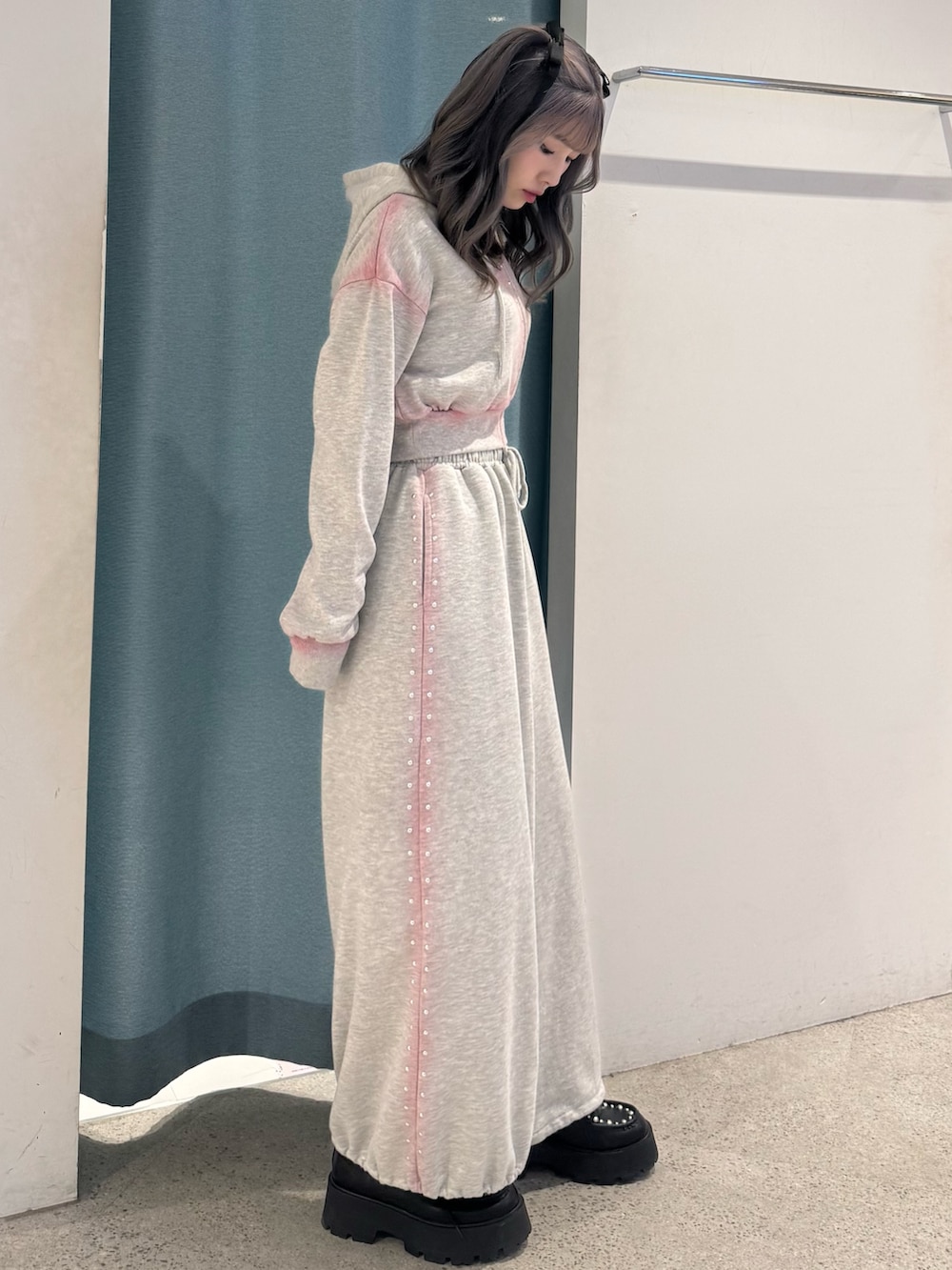 グレー系のパーカー、グレー系のスウェットパンツ、ブラック系のローファーを着用したレディースの春コーディネートの3枚目の写真