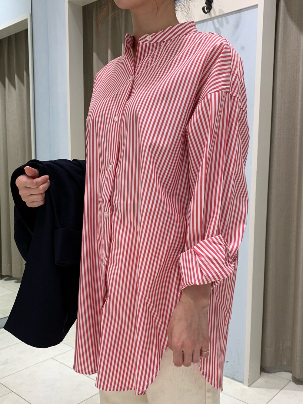 レッド系のシャツ/ブラウス、ブルー系のノーカラージャケット、ホワイト系のデニムパンツを着用したレディースの秋コーディネートの5枚目の写真