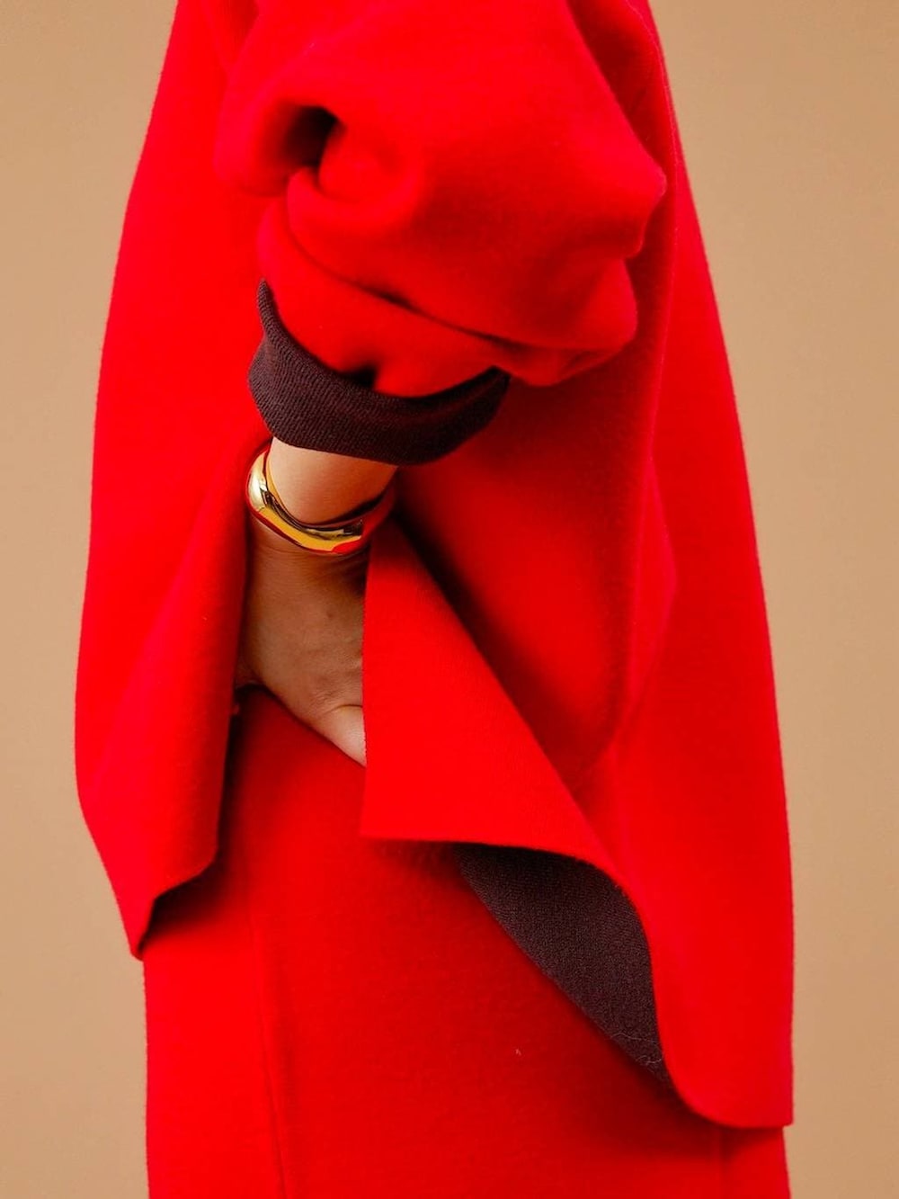 ベージュ系のチェスターコート、ブラウン系のショルダーバッグ、ブラウン系のブーツを着用したレディースの冬コーディネートの8枚目の写真