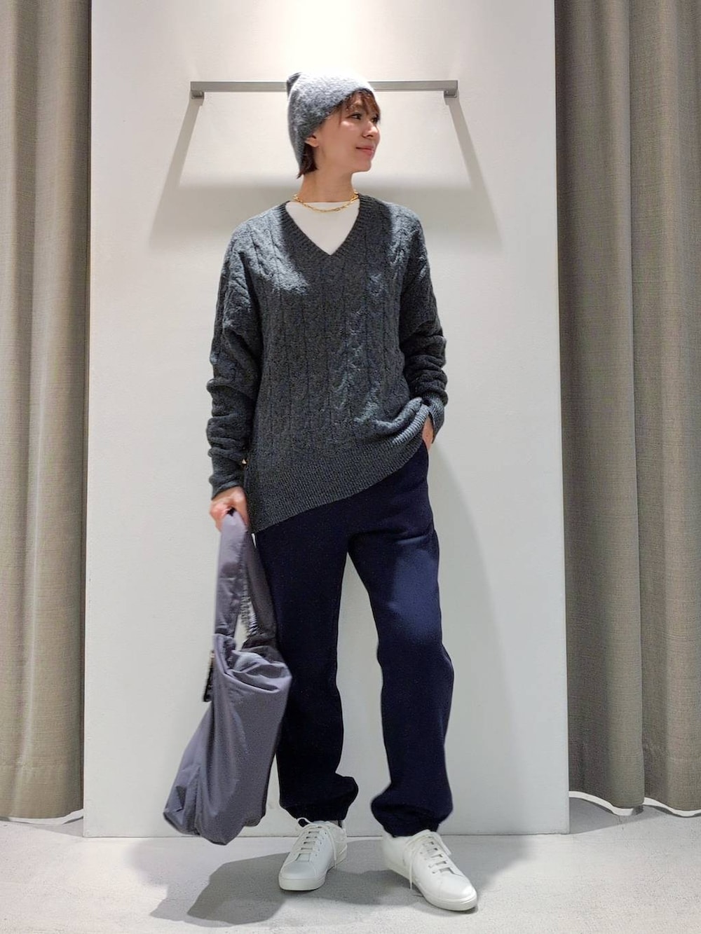 ホワイト系のTシャツ/カットソー、グレー系のショルダーバッグ、グレー系のニット/セーターを着用したレディースの秋コーディネートの5枚目の写真