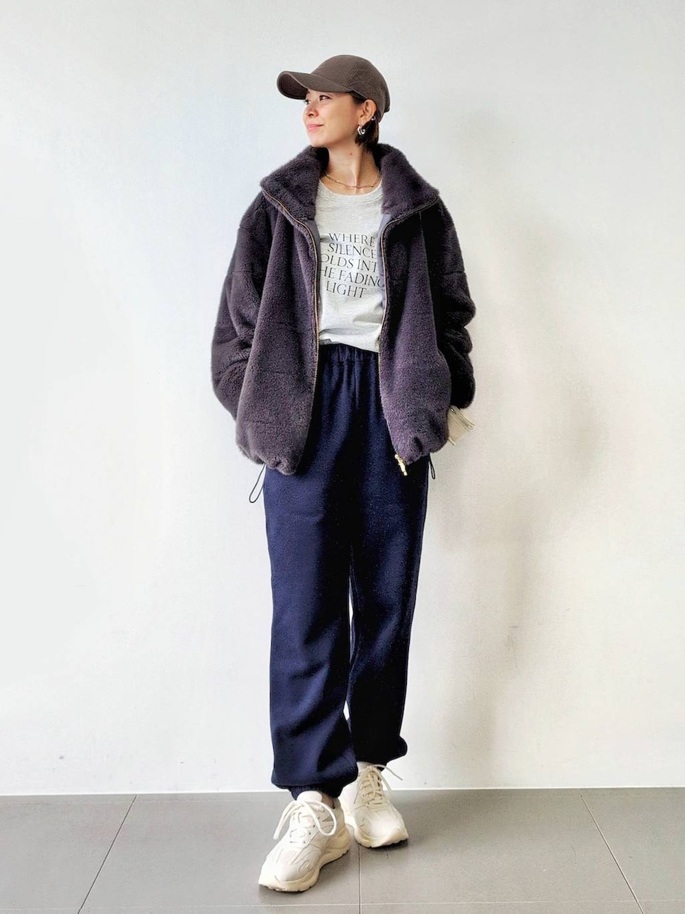 ホワイト系のショルダーバッグ、グレー系のブルゾン、ホワイト系のスニーカーを着用したレディースの秋コーディネートの4枚目の写真