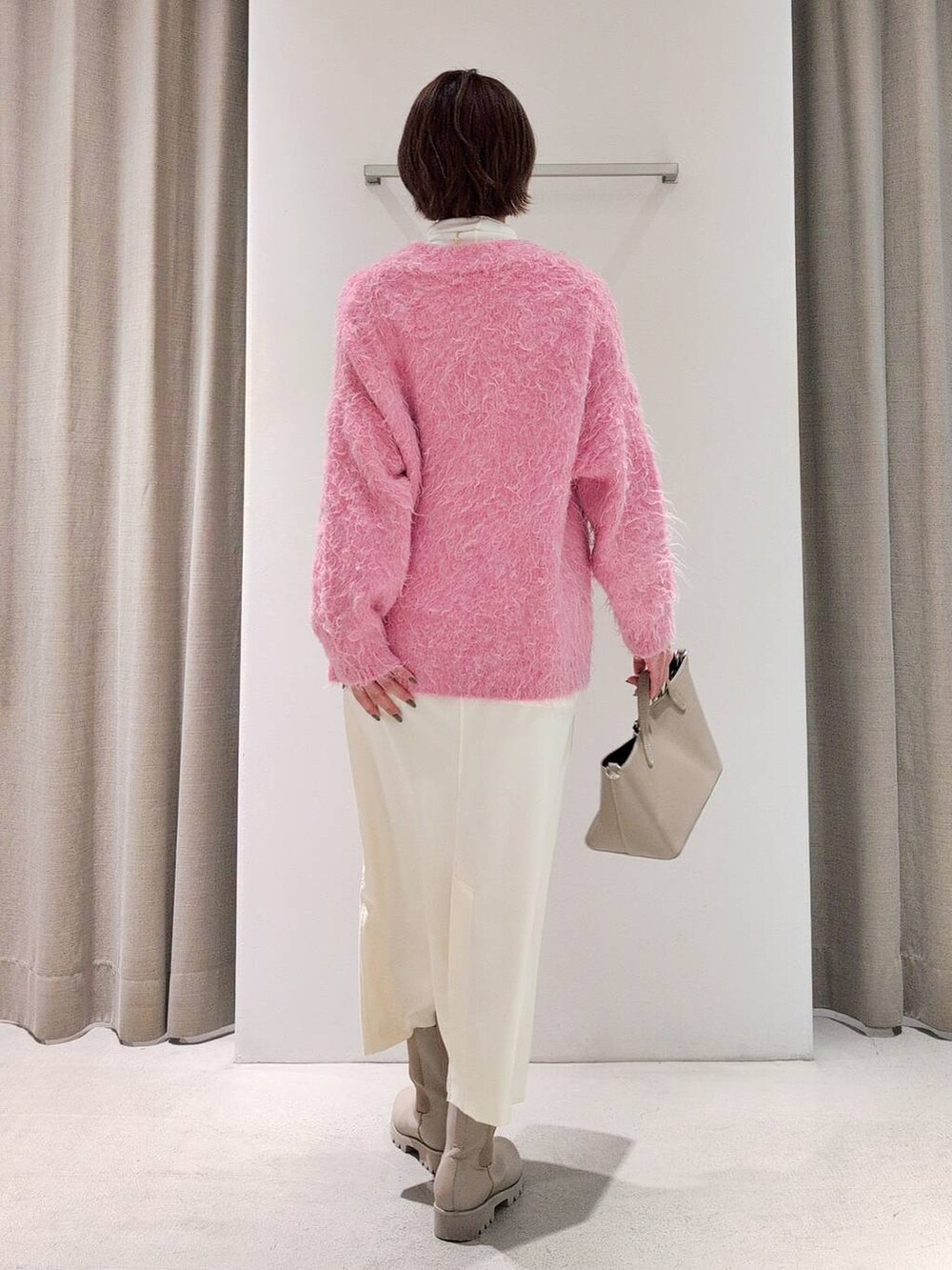 ホワイト系のTシャツ/カットソー、ベージュ系のピーコート、ホワイト系のスカートを着用したレディースの秋コーディネートの8枚目の写真