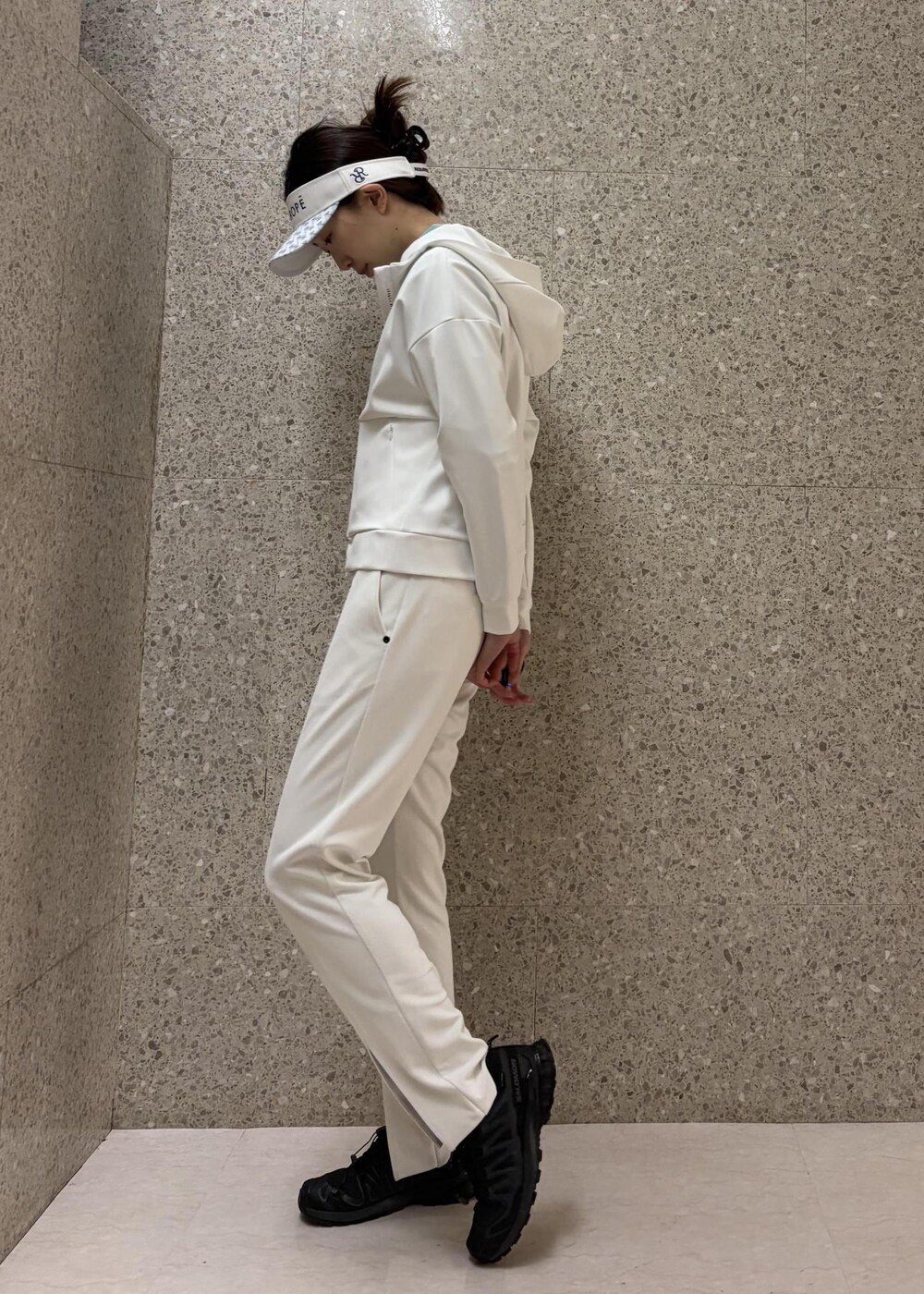 ホワイト系のブルゾン、グリーン系のニット/セーター、ホワイト系のサンバイザーを着用したレディースの冬コーディネートの5枚目の写真