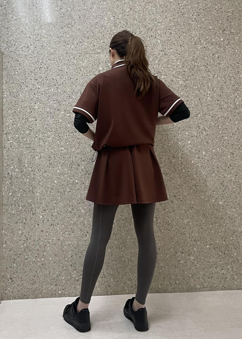 ブラウン系のスカート、ブラウン系のTシャツ/カットソーを着用したレディースの秋コーディネートの6枚目の写真