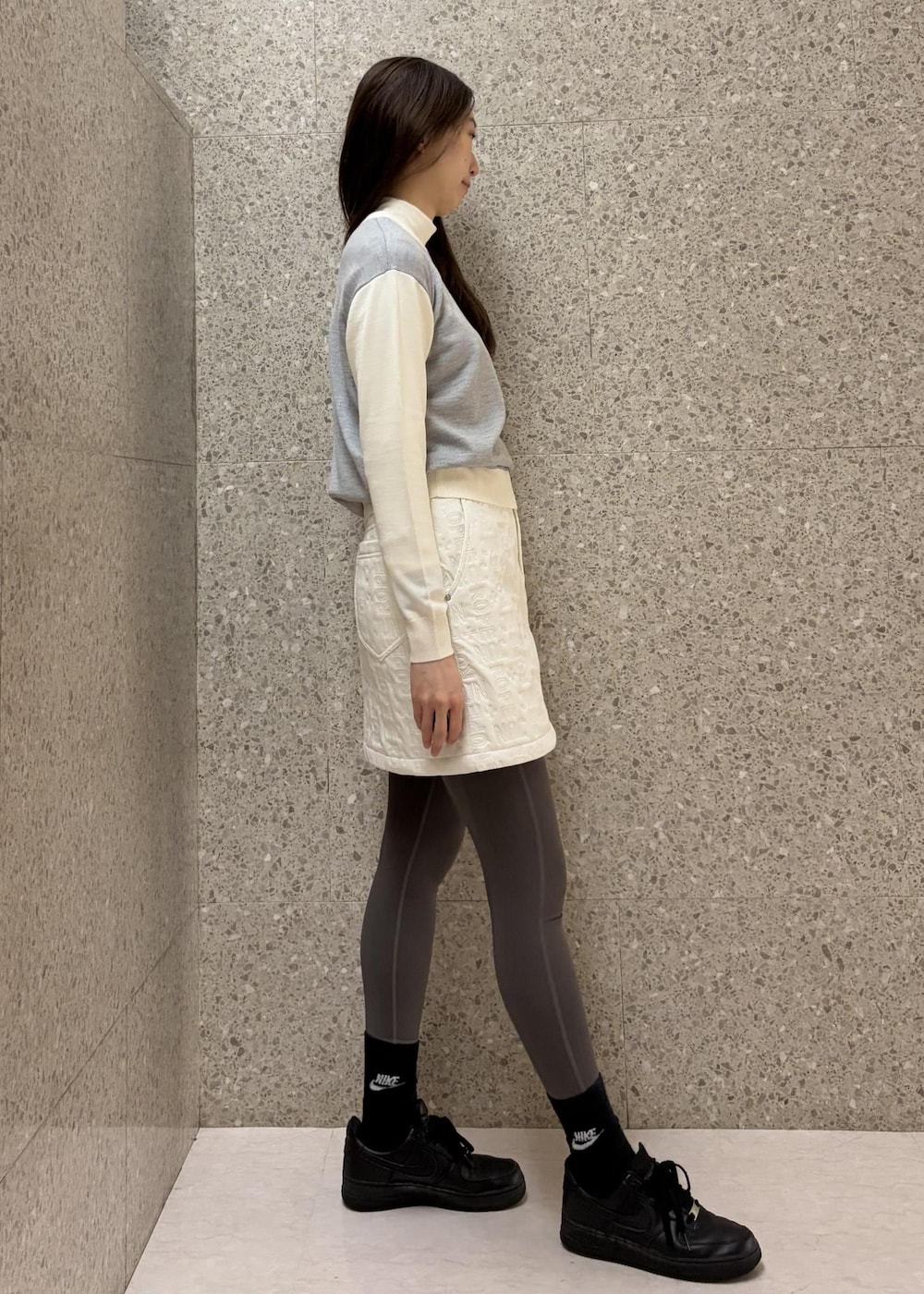 ホワイト系のTシャツ/カットソー、グレー系のニット/セーター、ホワイト系のスカートを着用したレディースの秋コーディネートの2枚目の写真