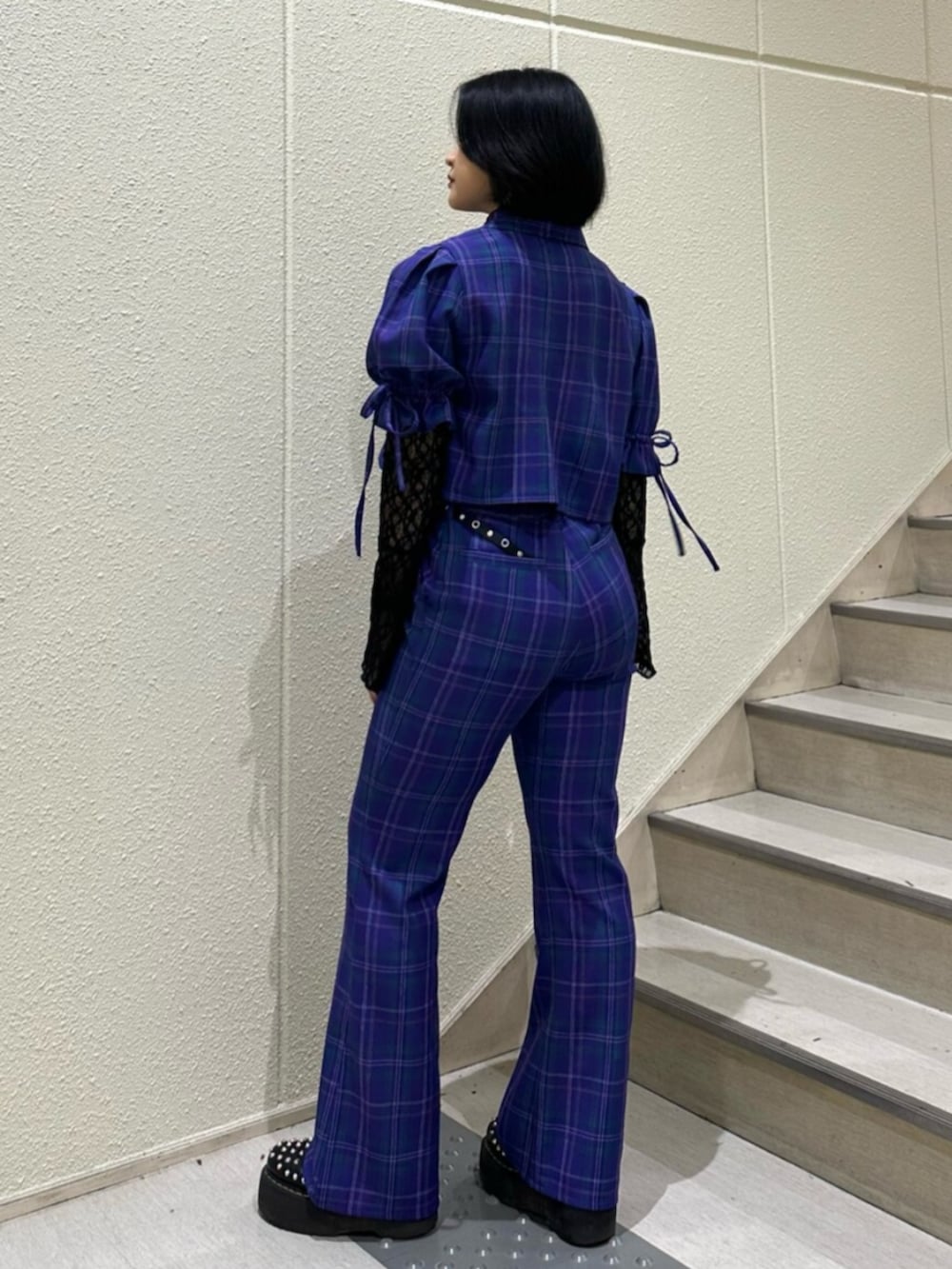 パープル系のテーラードジャケット、パープル系のその他パンツ、ブラック系のTシャツ/カットソーを着用したレディースの冬コーディネートの2枚目の写真