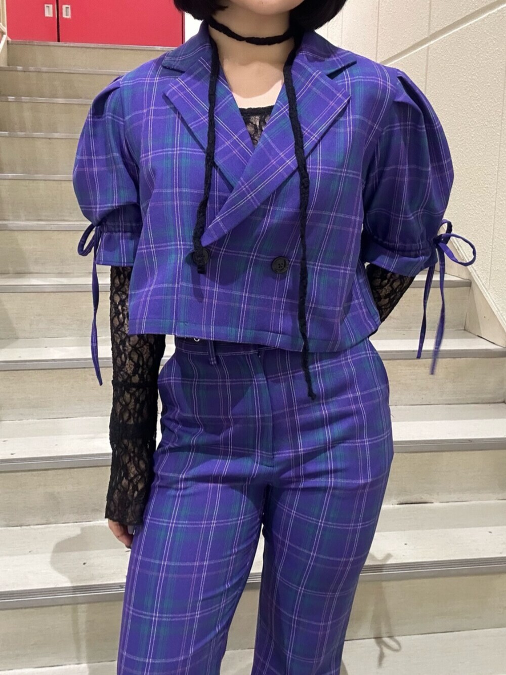 パープル系のテーラードジャケット、パープル系のその他パンツ、ブラック系のTシャツ/カットソーを着用したレディースの冬コーディネートの6枚目の写真