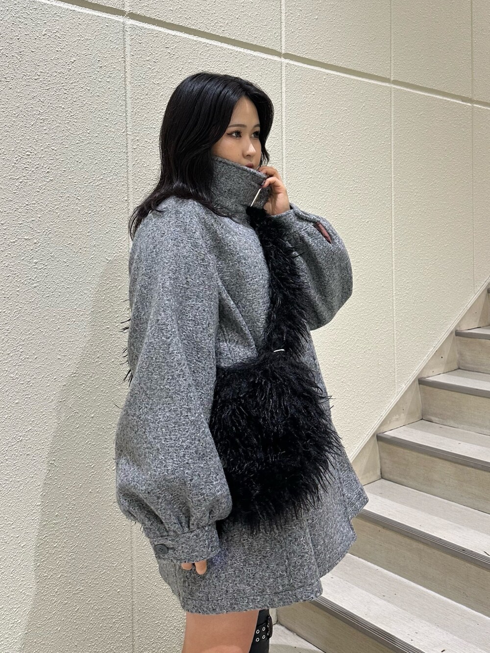 グレー系のその他アウター、ブラック系のショルダーバッグ、ブラック系のブーツを着用したレディースの秋コーディネートの5枚目の写真