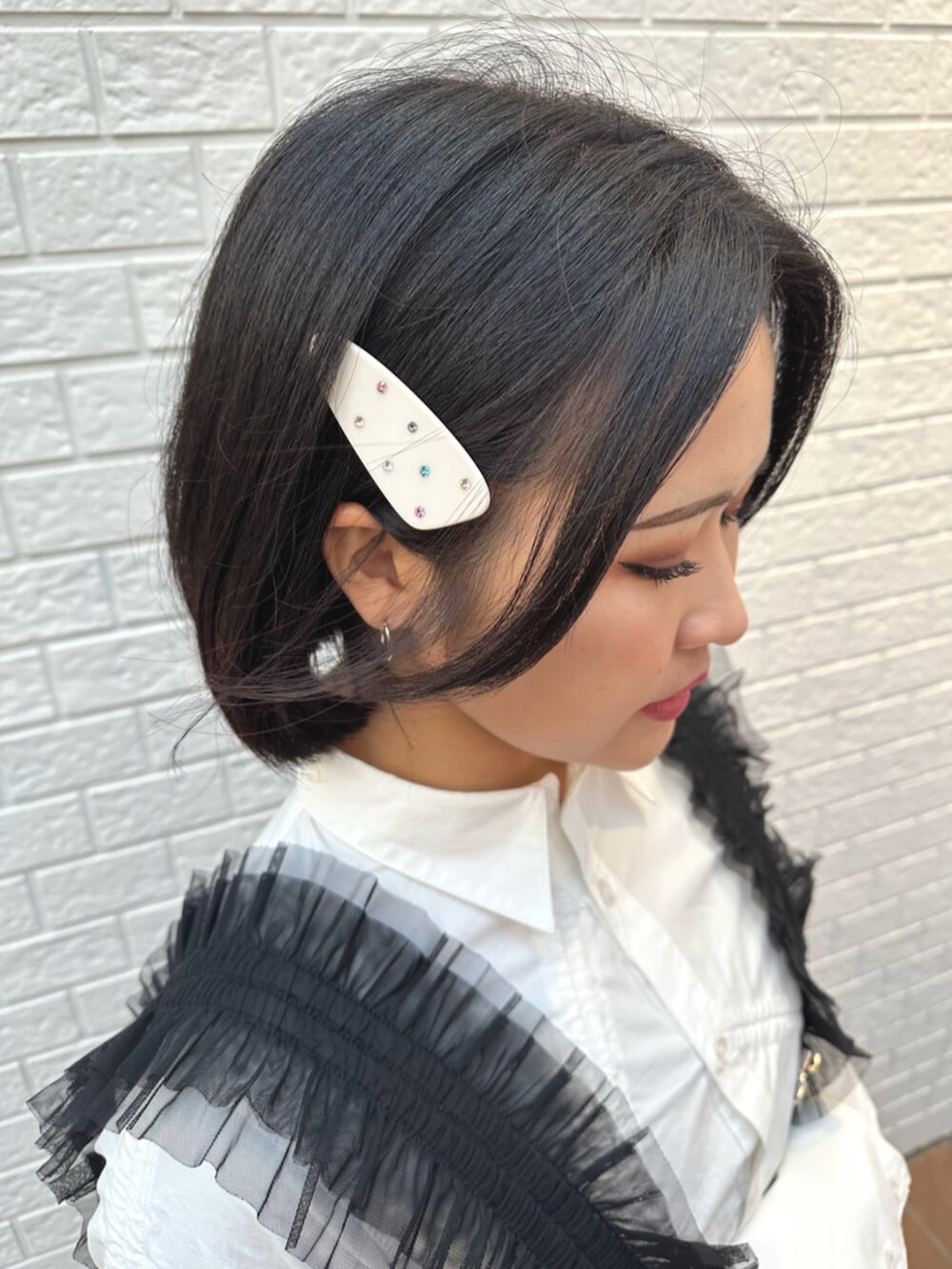 パープル系のスカート、ホワイト系のシャツ/ブラウス、ブラック系のサスペンダーを着用したレディースの冬コーディネートの6枚目の写真