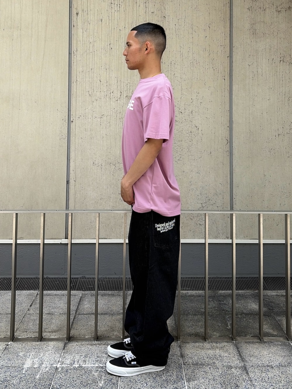ピンク系のTシャツ/カットソー、ブルー系のデニムパンツを着用したメンズの夏コーディネートの2枚目の写真