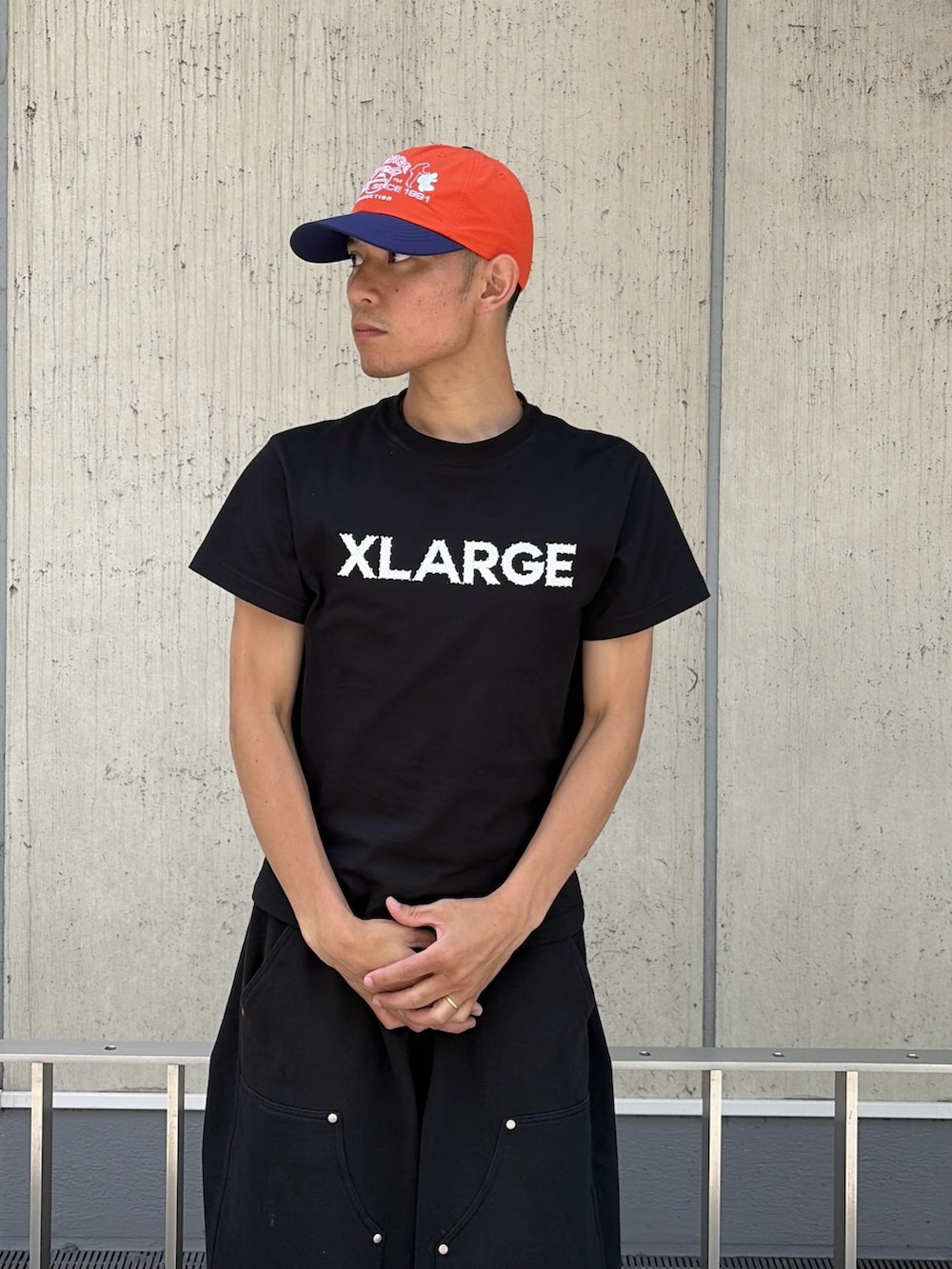 ピンク系のTシャツ/カットソー、グレー系のスウェットパンツ、オレンジ系のキャップを着用したメンズの夏コーディネートの5枚目の写真