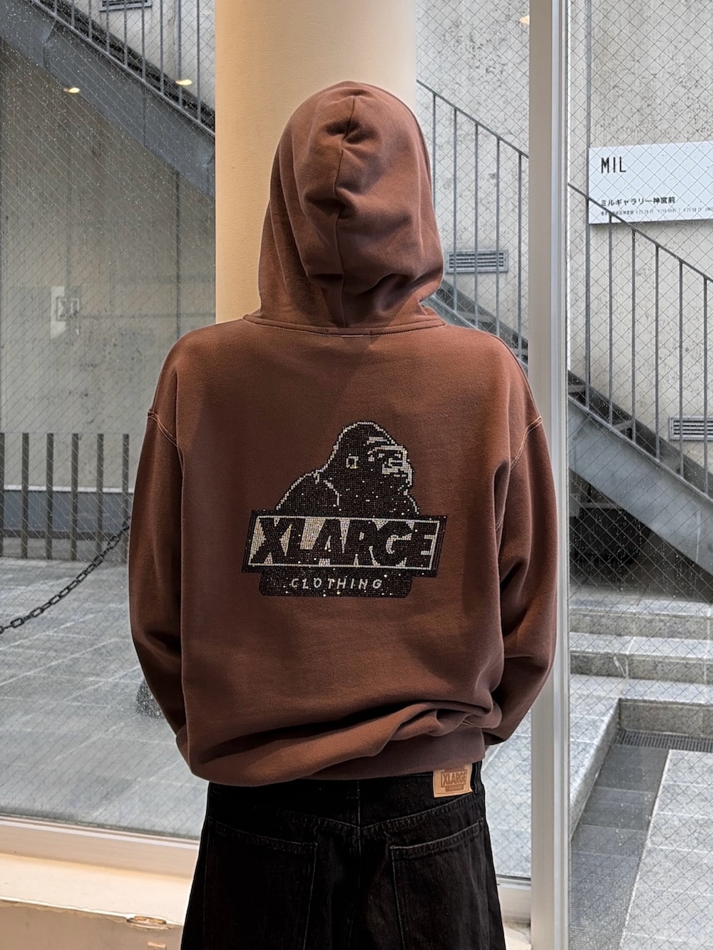ブラウン系のパーカー、ブルー系のデニムパンツ、ブラック系のキャップを着用したメンズの秋コーディネートの10枚目の写真
