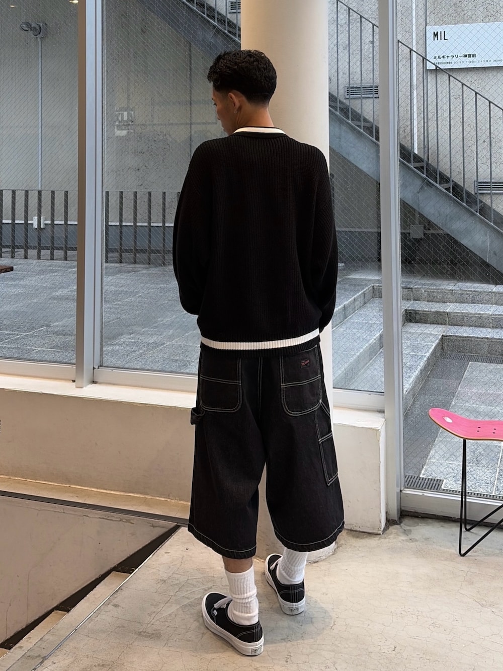 ブラック系のニット/セーター、ブラック系のデニムパンツを着用したメンズの秋コーディネートの5枚目の写真
