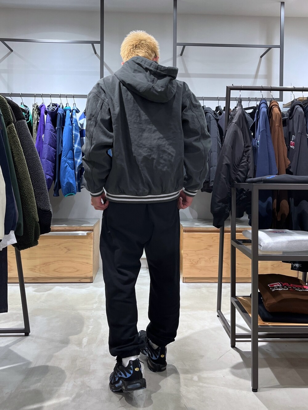 グリーン系のブルゾン、グレー系のスウェットパンツを着用したメンズの秋コーディネートの6枚目の写真