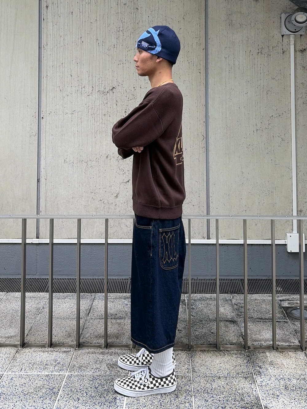 ブラウン系のニット/セーター、ブルー系のデニムパンツ、ブルー系のキャップを着用したメンズの秋コーディネートの3枚目の写真