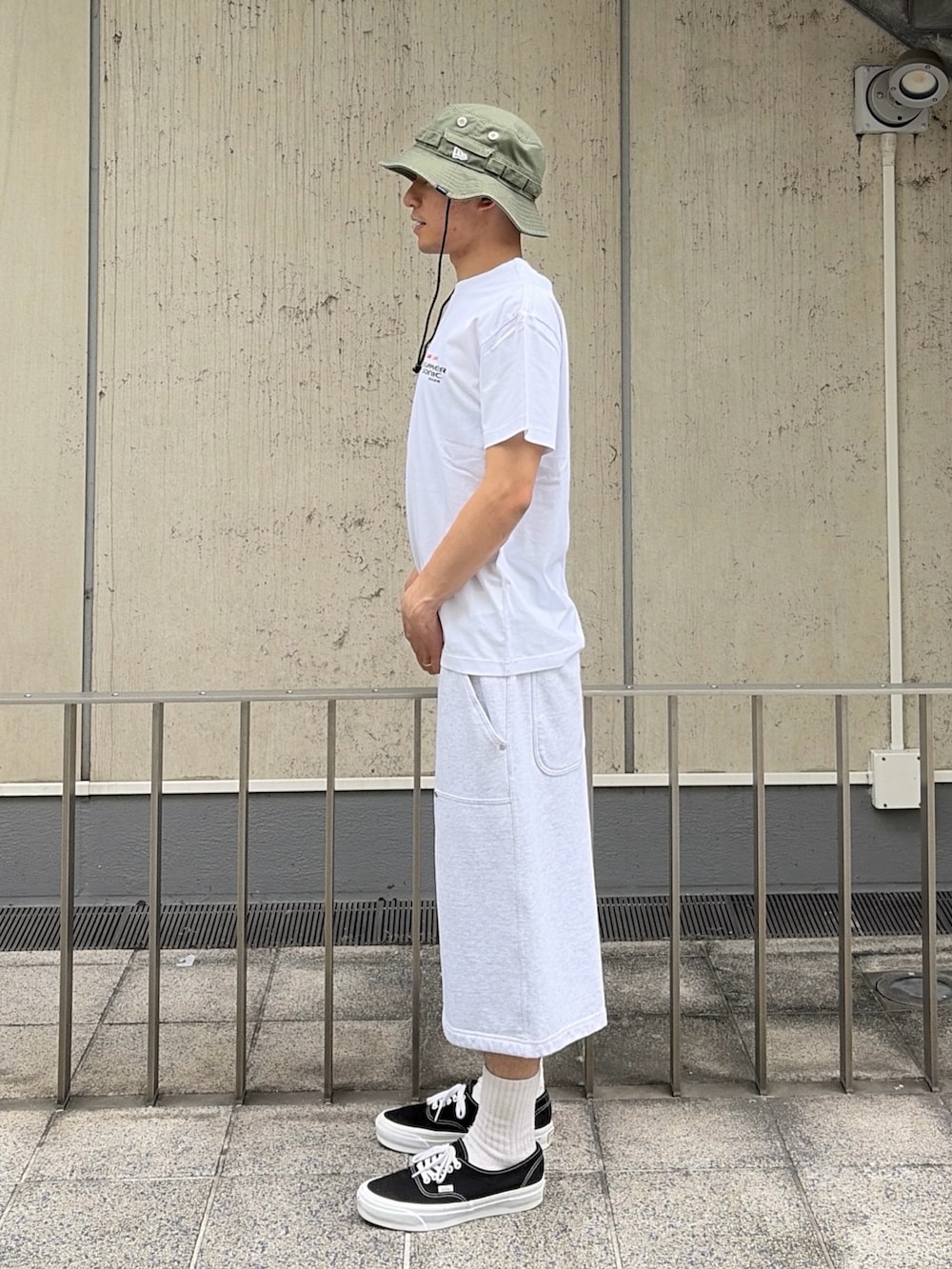グレー系のスウェットパンツ、ブルー系のベルト、ブラック系のハットを着用したメンズの夏コーディネートの2枚目の写真