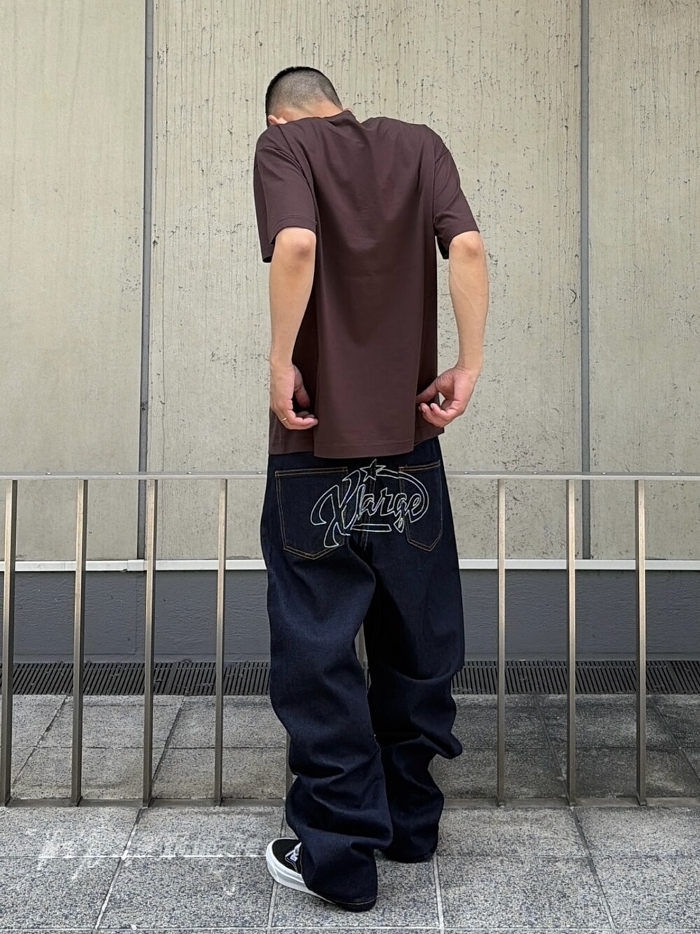ブラウン系のTシャツ/カットソー、ブラック系のデニムパンツを着用したメンズの夏コーディネートの5枚目の写真