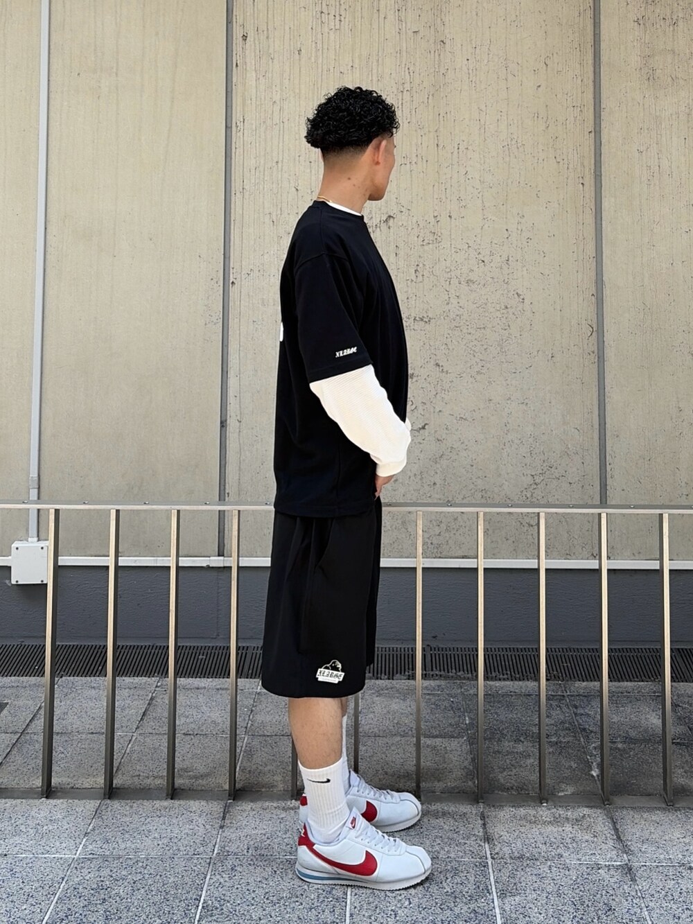 ブラック系のTシャツ/カットソー、ブラック系のその他パンツ、ホワイト系のTシャツ/カットソーを着用したメンズの夏コーディネートの5枚目の写真