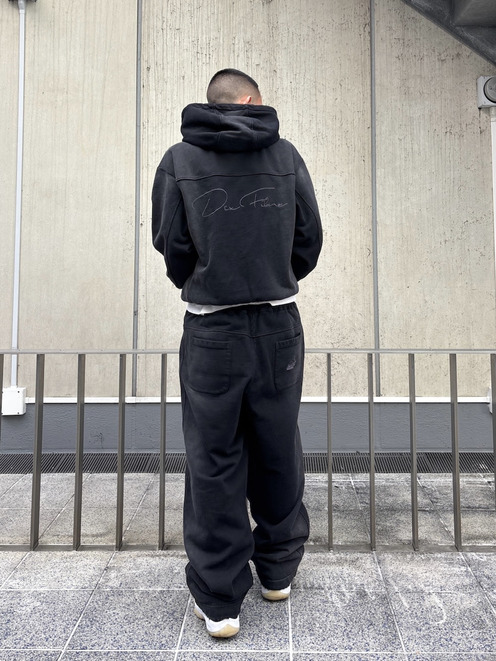 ブラック系のパーカー、ブラック系のスウェットパンツを着用したメンズの冬コーディネートの5枚目の写真