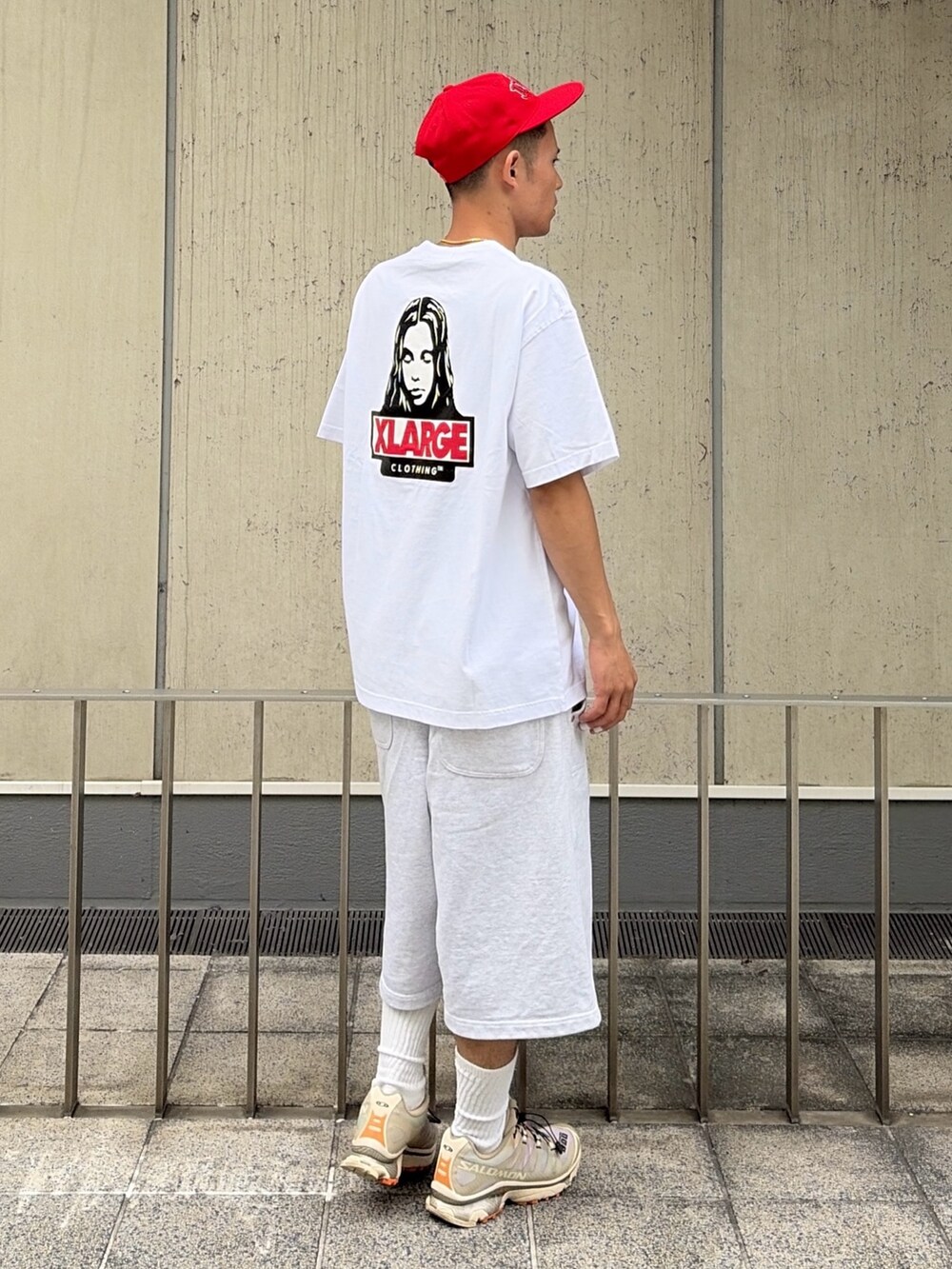 グレー系のスウェットパンツ、レッド系のキャップを着用したメンズの夏コーディネートの3枚目の写真