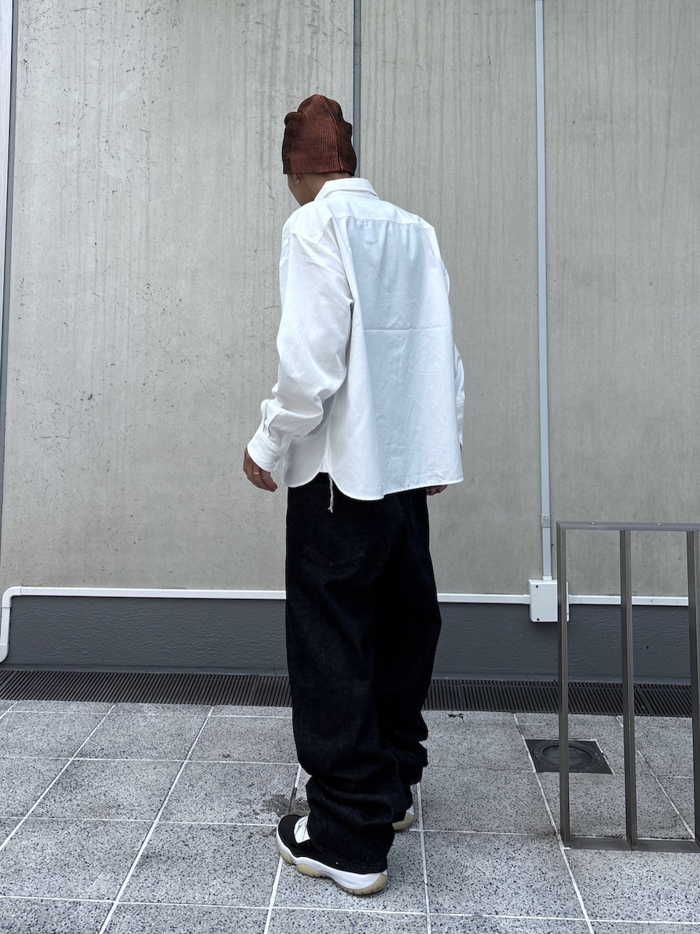 ホワイト系のシャツ/ブラウス、ブラック系のデニムパンツ、オレンジ系のニットキャップ/ビーニーを着用したメンズの秋コーディネートの4枚目の写真