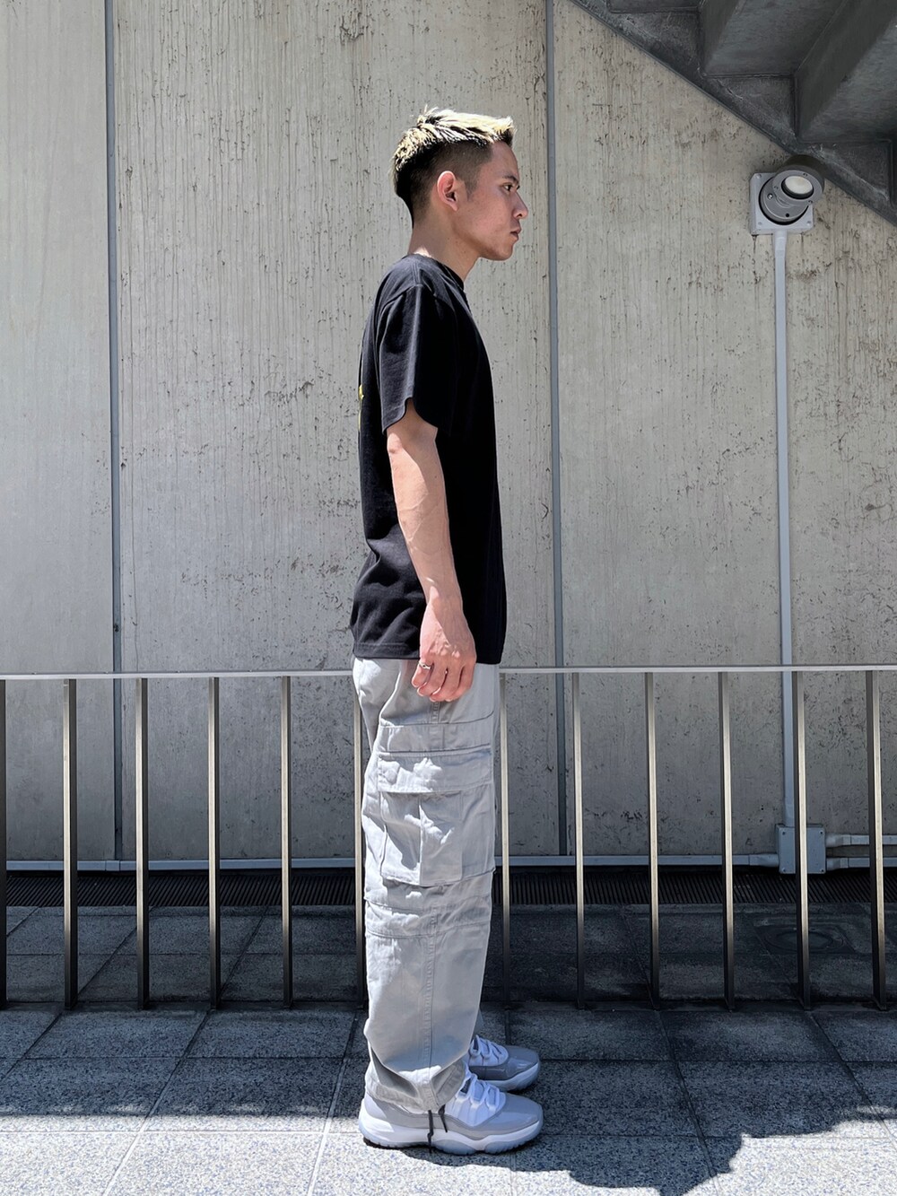 ブラック系のTシャツ/カットソー、グレー系のカーゴパンツを着用したメンズの夏コーディネートの5枚目の写真