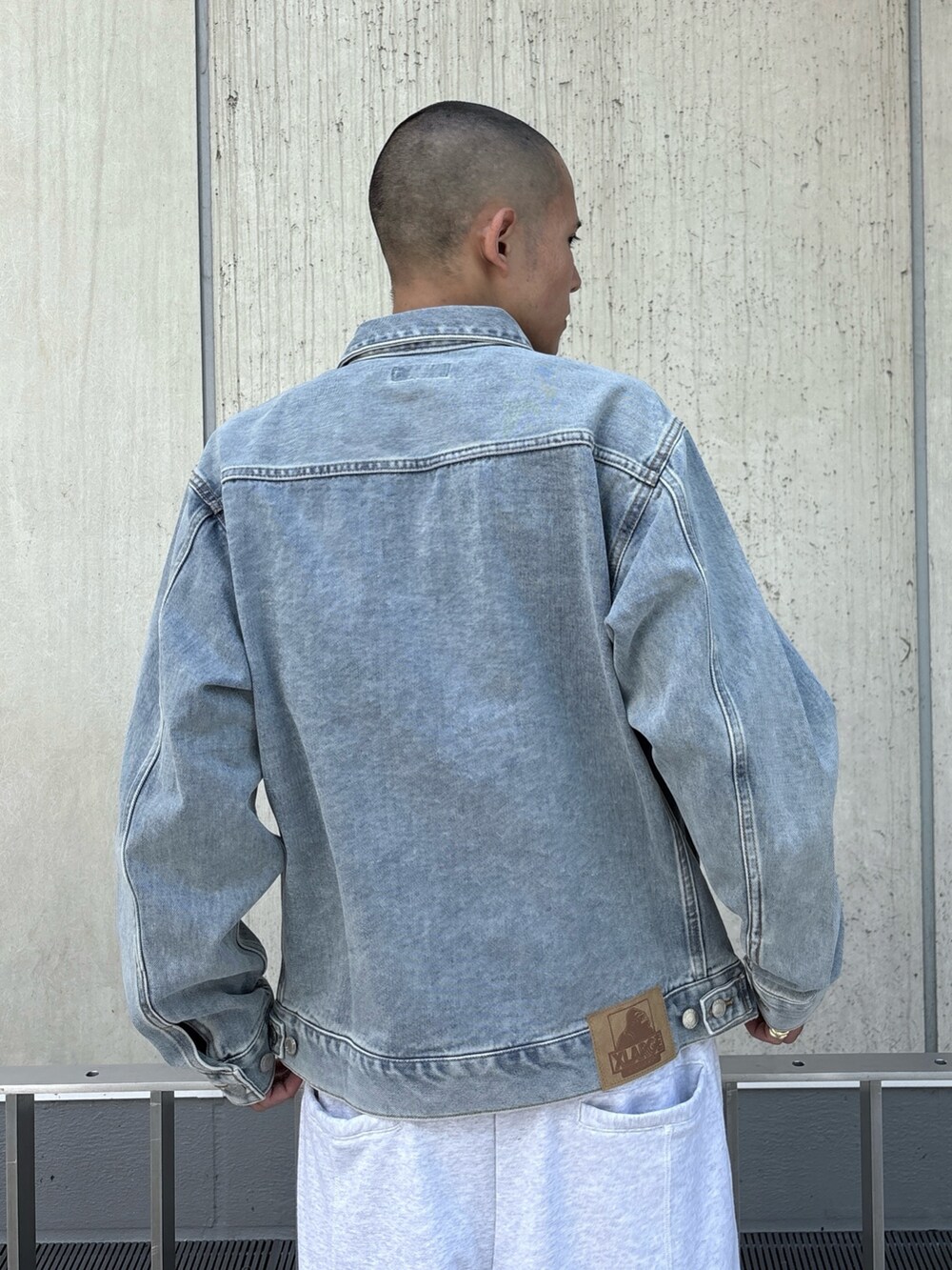 ブラック系のデニムジャケット、グレー系のスウェットパンツを着用したメンズの秋コーディネートの7枚目の写真