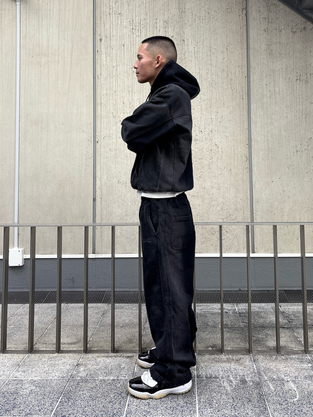 ブラック系のパーカー、ブラック系のスウェットパンツを着用したメンズの冬コーディネートの3枚目の写真